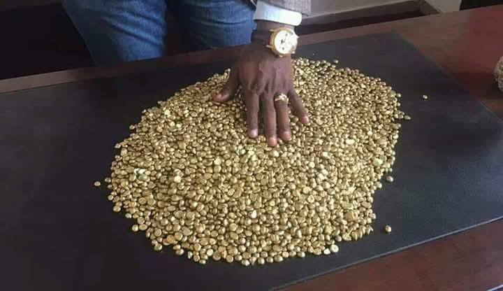 Gold grains poured on a desk